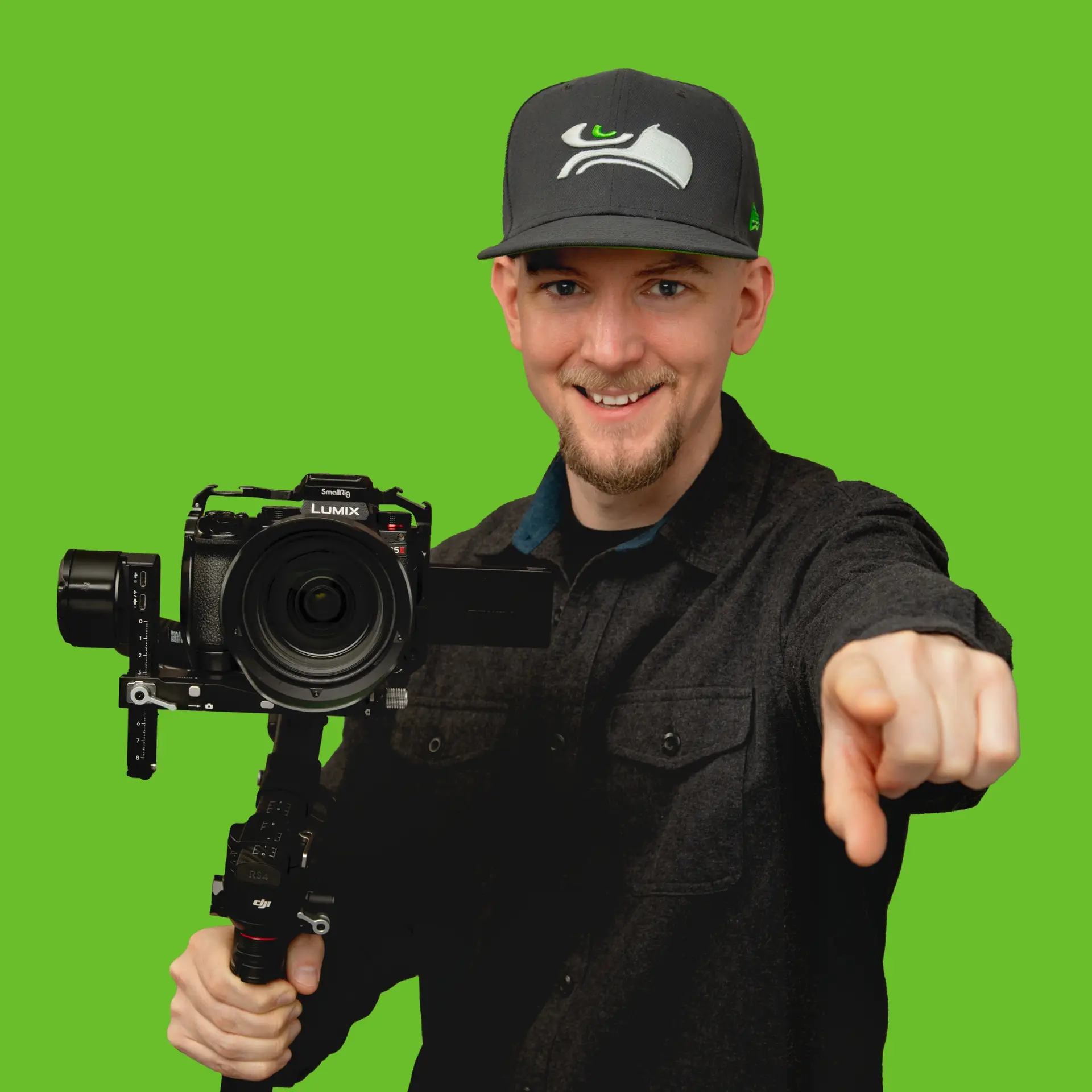 Ryan Miller holding a cinema camera on a gimbal and pointing at the viewer